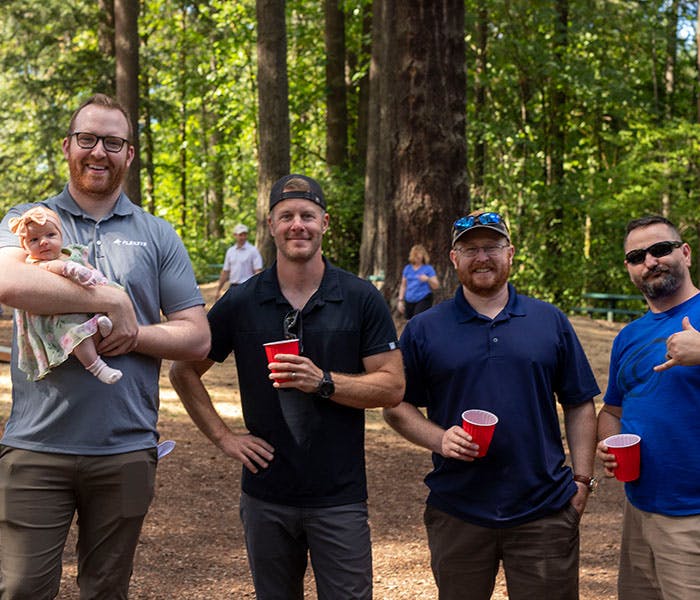 Employees hanging out at a company picnic