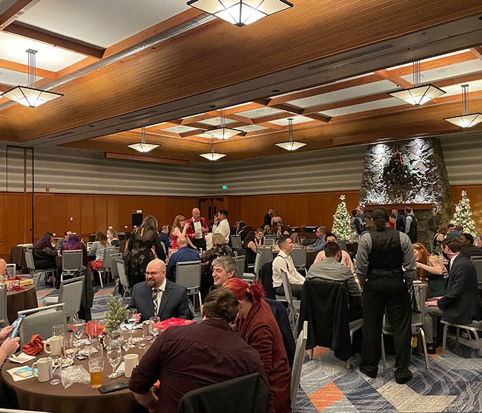 Employees enjoying a meal at a company holiday party