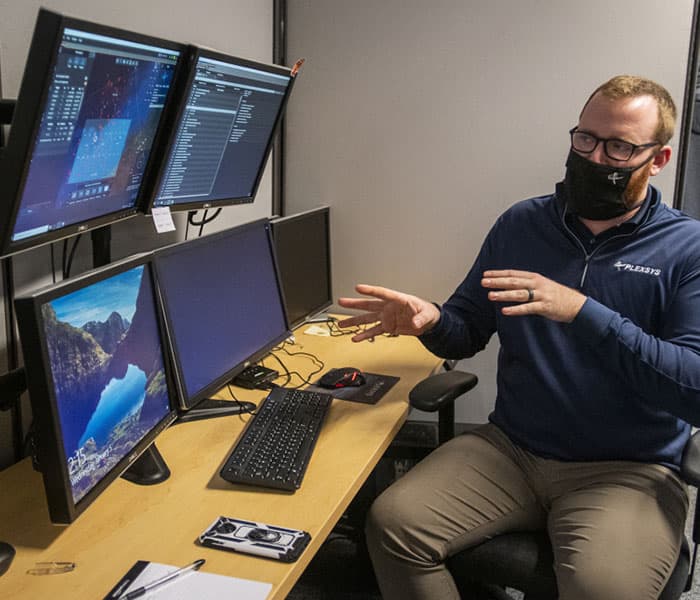 Employee showing off his work on a computer screen