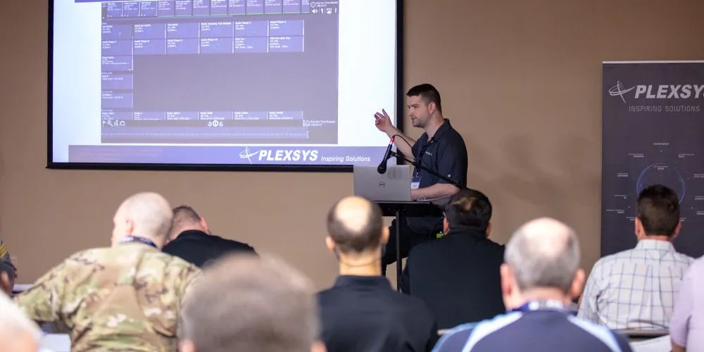 PLEXSYS Employee Giving Presentation to room of Military