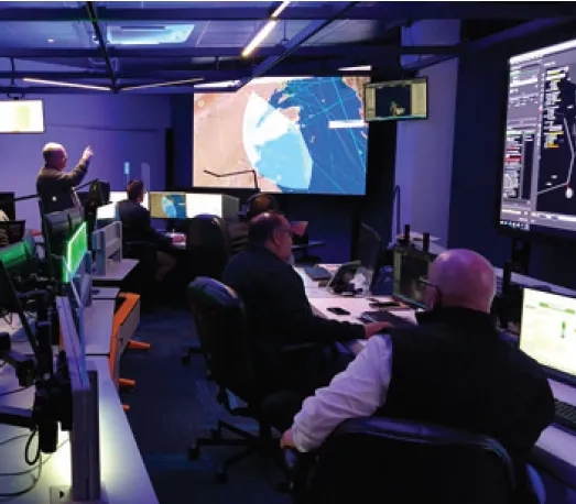 People in a mission control room
