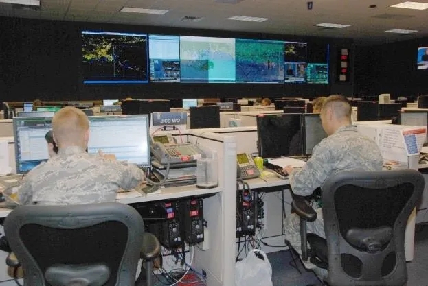 Soldiers working in a mission control center